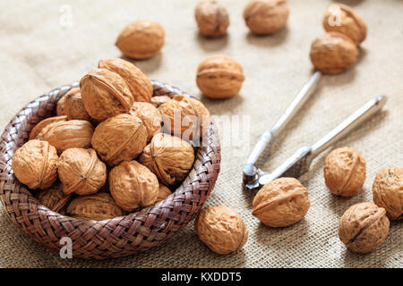 Walnuts in a small basket on a table Stock Photo
