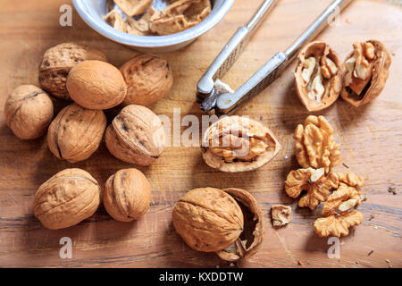 Walnuts and a nutcracker on a table Stock Photo