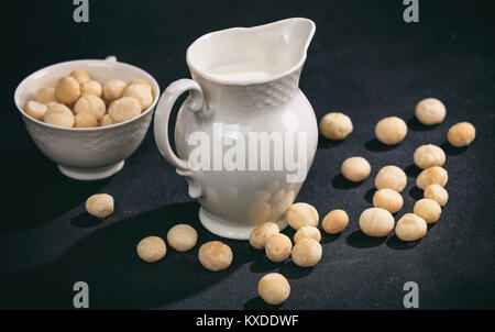 Milk from macadamia nuts on black background Stock Photo