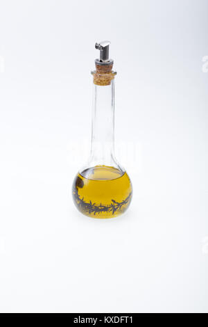 Thyme infused olive oil over white background Stock Photo