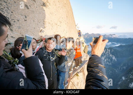 Mount Hua, Shaanxi Province, China - October 6, 2017: Tourists on the Plank Walk in the Sky, worlds most dangerous hike. Stock Photo