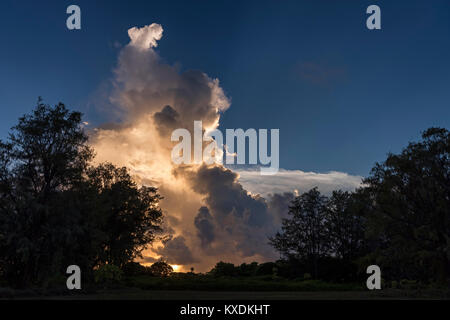 Clouds illuminated by setting sun on Bird Island, Seychelles, Indian Ocean Stock Photo