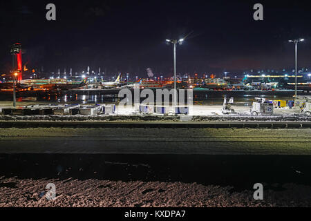 Night view of the operations mess and delays at the John F. Kennedy International Airport (JFK) after the bomb cyclone winter snow storm Grayson. Stock Photo