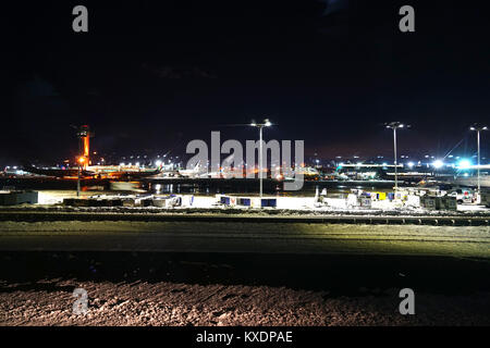 Night view of the operations mess and delays at the John F. Kennedy International Airport (JFK) after the bomb cyclone winter snow storm Grayson. Stock Photo