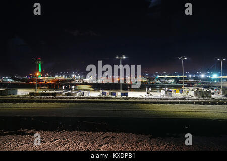 Night view of the operations mess and delays at the John F. Kennedy International Airport (JFK) after the bomb cyclone winter snow storm Grayson. Stock Photo