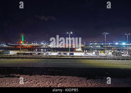 Night view of the operations mess and delays at the John F. Kennedy International Airport (JFK) after the bomb cyclone winter snow storm Grayson. Stock Photo