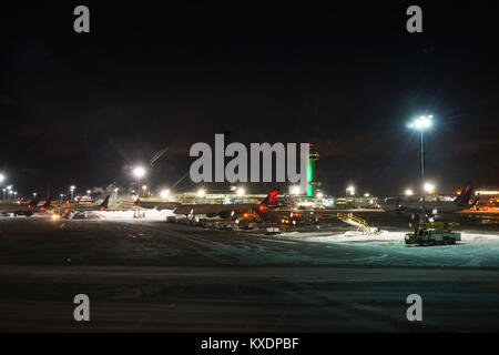 Night view of the operations mess and delays at the John F. Kennedy International Airport (JFK) after the bomb cyclone winter snow storm Grayson. Stock Photo