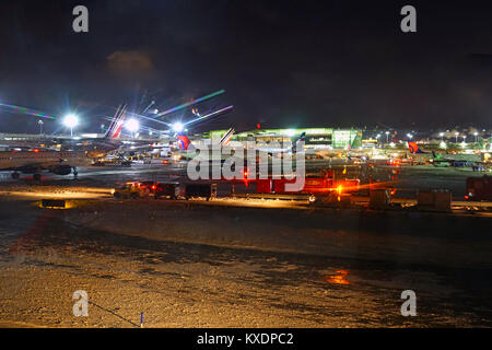 Night view of the operations mess and delays at the John F. Kennedy International Airport (JFK) after the bomb cyclone winter snow storm Grayson. Stock Photo