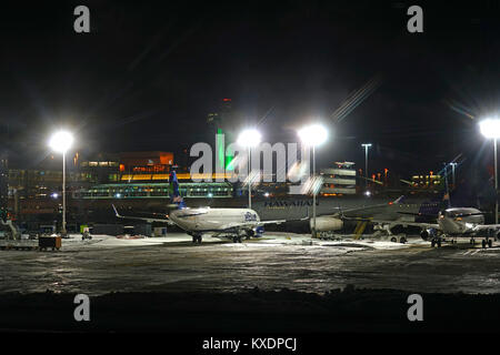 Night view of the operations mess and delays at the John F. Kennedy International Airport (JFK) after the bomb cyclone winter snow storm Grayson. Stock Photo