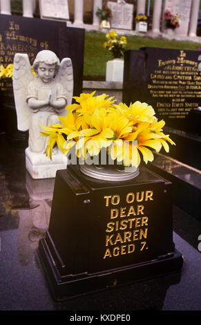 UK, Wales, Glamorgan, Aberfan, Cemetery floral tribute on disaster memorial to 7 year old victim Stock Photo