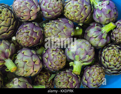 Fresh artichokes on plate Stock Photo