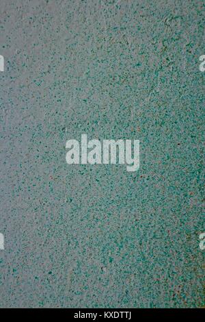 Spray painted white wall background with turquoise dappled paint. Stock Photo