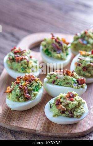 Bacon guacamole deviled eggs Stock Photo