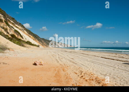 The golden sands of 75 mile beach extending into the horizon with sandbank, sea and blue sky