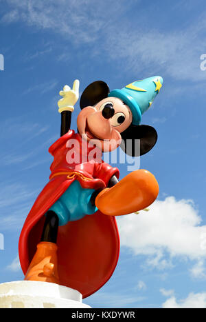 Monchique, Faro - Portugal, 30th, March 2013. Studio image of Mickey Mouse fantasia figure Standing on a wall with a blue sky background. Stock Photo