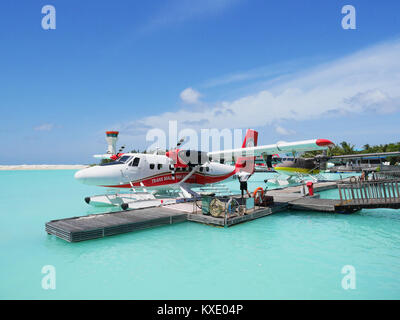 MALE, MALDIVES - JULY 14, 2017: Pilot preparing for a seaplane flight at Male seaplane terminal. He will then take passengers to their choices of isla Stock Photo