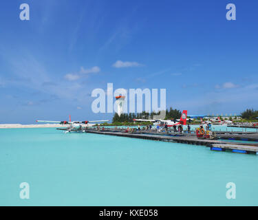 MALE, MALDIVES - JULY 14, 2017: Tourists preparing to get on a seaplane at Male seaplane terminal. They will then be taken to their choices of island  Stock Photo