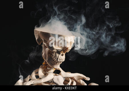 Skeleton with smoke coming out of open skull, open mind concept Stock Photo