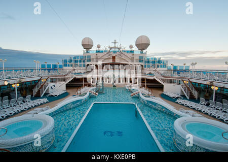 View of top deck of cruise ship with luxurious pools and spa facilities. Stock Photo