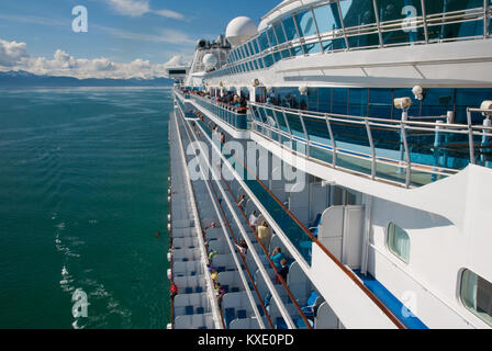 Holiday makers on board Princess Diamond cruise ship looking at beautiful scenery. Stock Photo