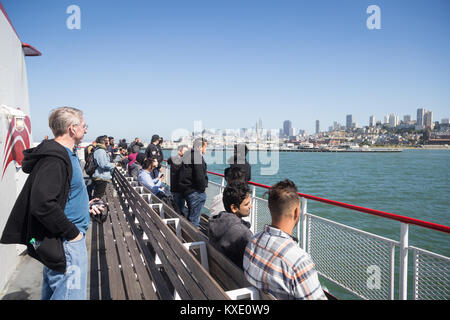 San Francisco, USA - July 1, 2017: People enjoy the view of the San Francisco skyline from a cruise tour boat in the Bay of San Francisco on a sunny d Stock Photo