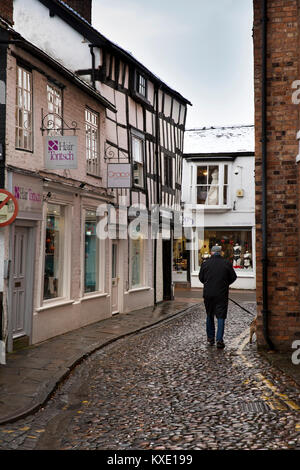 UK, England, Cheshire, Nantwich, Church Lane, man walking dog in narrow cobbled road Stock Photo