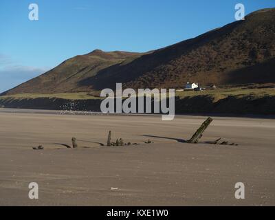 Remains of the wreck of the Helvetia at Rhossili Bay, Gower with the 'Old Rectory' in the background Stock Photo