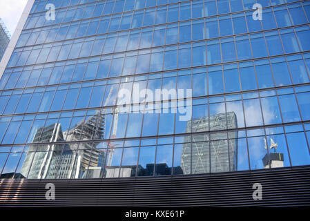 Financial district of the City of London reflected in a glass structured building. The Scalpel, Cheesegrater, Willis Building and 22 Bishopsgate Stock Photo