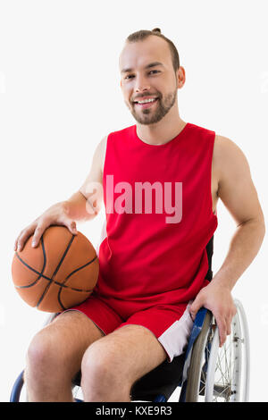 sportsman in wheelchair with basketball ball Stock Photo