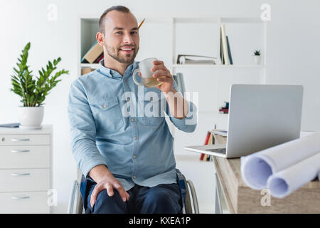 disabled businessman drinking coffee Stock Photo