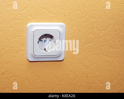 Indoor electric power line socket on yellow wall Stock Photo