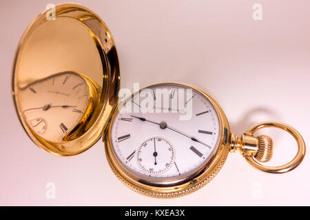 Solid gold pocket watch (14 karat), manufactured by the Illinois Watch Company in Springfield USA, late 1800s. Ladies' size watch in a hunter case. Stock Photo