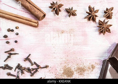 Star anise, chocolate, cinnamon and cloves on wooden table. Selective focus. Top view or flat lay Stock Photo