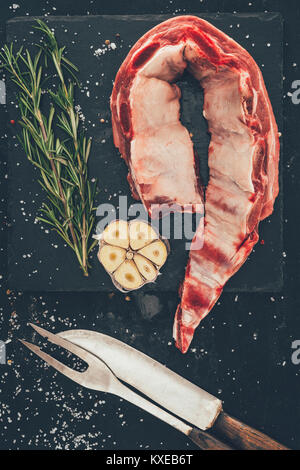 top view of pork ribs slice with spices and cutlery on stone slate Stock Photo