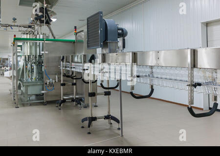 Plastic transparent bottles move on the conveyor.Plastic bottles on the conveyor Stock Photo