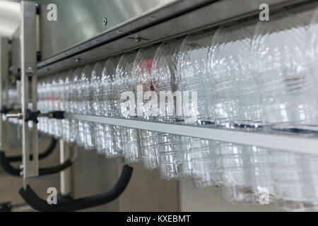 Plastic transparent bottles move on the conveyor.Plastic bottles on the conveyor Stock Photo