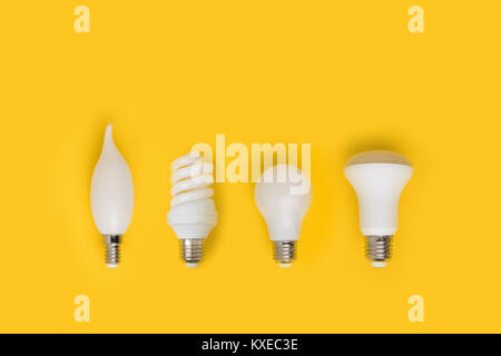 top view of set of different white lamps isolated on yellow Stock Photo