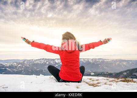 Female hiker on snow covered mountain top. Winter active lifestyle Stock Photo