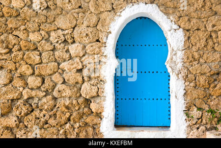 Traditional powder blue painted house facade and door in the historical Medina of Chefchaouen, Morocco Stock Photo