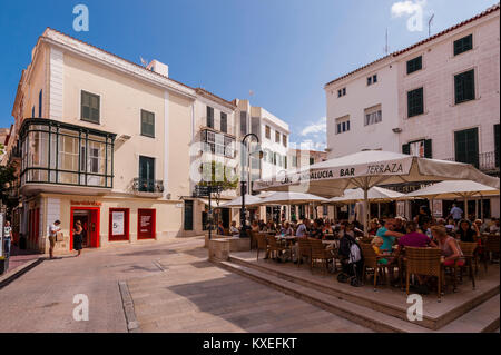 People sitting outside at a bar cafe in Mahon , Menorca , Balearic Islands , Spain Stock Photo