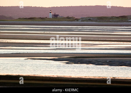 Barnstable Harbor Light on Sandy Neck as seen from Chapin Beach in Dennis, Massachusetts on Cape Cod -- During sunset Stock Photo