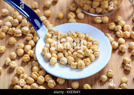 Roasted chickpeas and an old ladle on a table Stock Photo