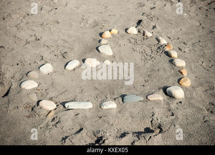 Loveheart made of Stones on a sandy beach Stock Photo