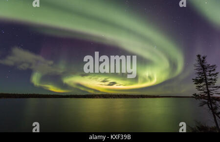Aurora Borealis swirling in the night sky above Long Lake, Yellowknife, Northwest Territories, Canada.Aurora season is from late August to late March. Stock Photo