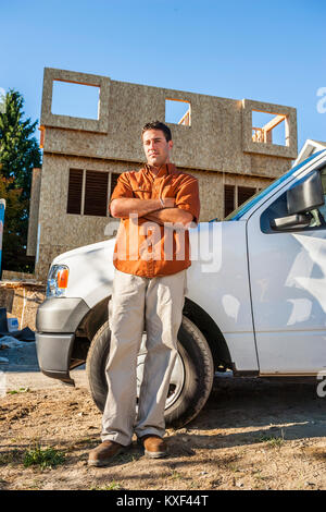 A contractor posed for a portrait on a residential work site. Stock Photo