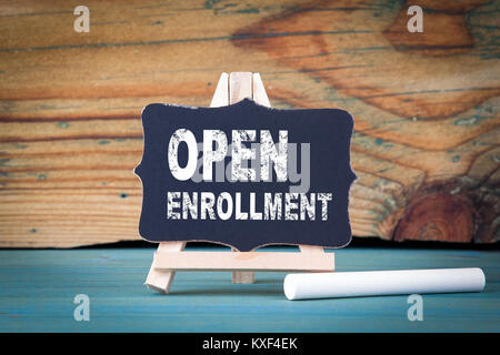 Open Enrollment. small wooden board with chalk on the table Stock Photo