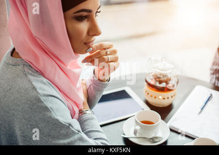 Portrait of a beautiful Muslim woman in cafe Stock Photo