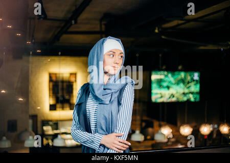 Portrait of a beautiful Muslim woman in cafe Stock Photo