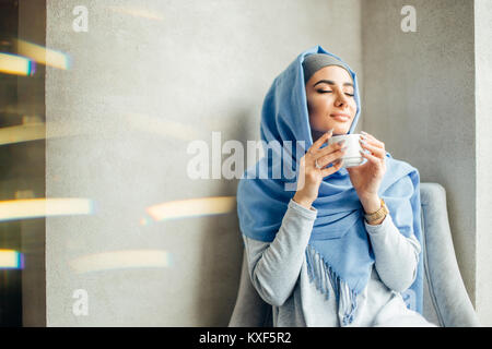 pretty muslim girl in hijab in cafe Stock Photo