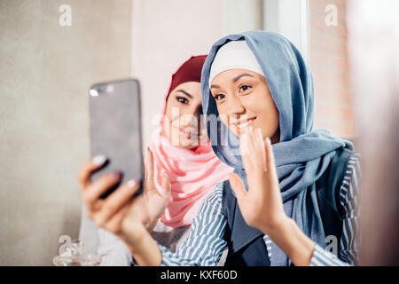 Two Muslim woman friend selfie by smartphone Stock Photo